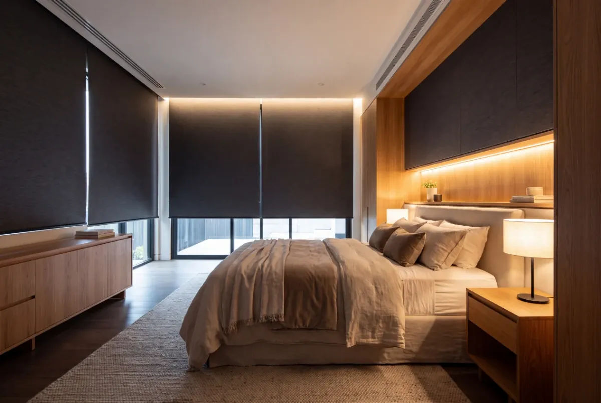 Blockout blinds lowered in a main bedroom